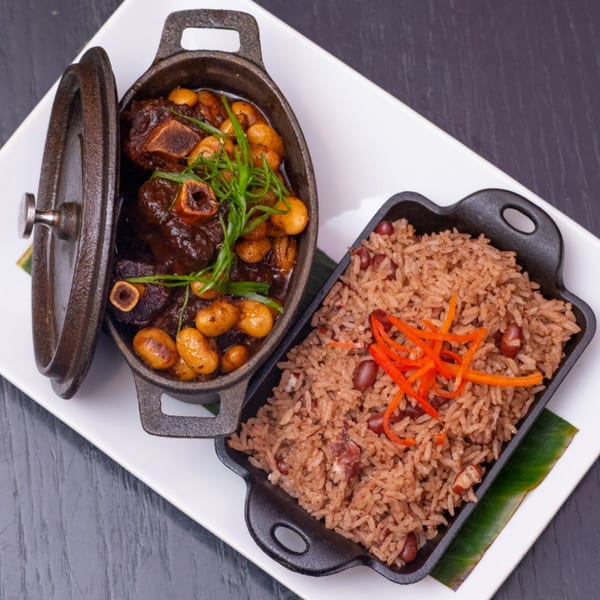 Krave's Jamaican oxtail stew with butter beans and rice and peas in cast iron dishes.